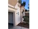 Side view of home, highlighting stucco siding, attached garage and well-maintained landscape at 6965 Coral Rock Dr, Las Vegas, NV 89108