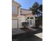 Inviting two-story home with stucco siding, a covered entry, attached garage and mature landscaping at 6965 Coral Rock Dr, Las Vegas, NV 89108