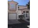 Inviting two-story home with stucco siding, a covered entry, attached garage and well-maintained landscaping at 6965 Coral Rock Dr, Las Vegas, NV 89108