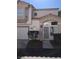 Inviting two-story home with stucco siding, a covered entry, attached garage and well-maintained landscaping at 6965 Coral Rock Dr, Las Vegas, NV 89108