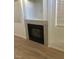 Cozy fireplace with white tile surround, situated between two windows for natural light at 6965 Coral Rock Dr, Las Vegas, NV 89108
