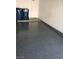 Close up of the garage's epoxy flooring with trash cans at 6965 Coral Rock Dr, Las Vegas, NV 89108