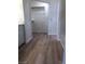 Bright hallway with wood-look vinyl flooring leads to a walk-in closet, offering ample storage at 6965 Coral Rock Dr, Las Vegas, NV 89108