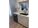 Kitchen featuring a stainless steel dishwasher, sink, and white cabinets at 6965 Coral Rock Dr, Las Vegas, NV 89108