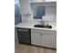 Kitchen featuring a stainless steel dishwasher, sink, and white cabinets at 6965 Coral Rock Dr, Las Vegas, NV 89108