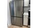 Kitchen featuring a stainless steel refrigerator, oven, and white cabinets at 6965 Coral Rock Dr, Las Vegas, NV 89108