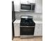 Kitchen featuring stainless steel oven and microwave with white cabinets at 6965 Coral Rock Dr, Las Vegas, NV 89108