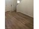 View of a bright entryway and living area with modern wood floors and staircase at 6965 Coral Rock Dr, Las Vegas, NV 89108