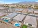 Aerial view of neighborhood homes with pools, desert landscaping and mountain views at 71 Gosia Grove Ave, North Las Vegas, NV 89031