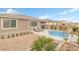 Backyard with a pool, rock waterfall feature and desert landscaping at 71 Gosia Grove Ave, North Las Vegas, NV 89031