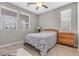 Comfortable bedroom featuring a twin bed, a three-drawer dresser, and great natural lighting from the windows at 71 Gosia Grove Ave, North Las Vegas, NV 89031