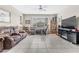 Spacious living room with a large window, comfortable sofa, and entertainment center with a large screen TV at 71 Gosia Grove Ave, North Las Vegas, NV 89031