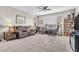Bright living room featuring a comfortable brown sofa and a well-lit reading nook with a bookcase at 71 Gosia Grove Ave, North Las Vegas, NV 89031