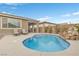 Backyard pool with rock waterfall feature and covered patio in view at 71 Gosia Grove Ave, North Las Vegas, NV 89031