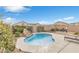 Backyard pool with rock waterfall feature and lounge chairs at 71 Gosia Grove Ave, North Las Vegas, NV 89031