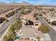 Expansive aerial view of a residential neighborhood with pools, tree-lined streets, and mountain views at 837 Roseberry Dr, Las Vegas, NV 89138