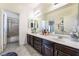 Elegant bathroom featuring double vanity sinks, tile flooring, and a separate shower and tub at 837 Roseberry Dr, Las Vegas, NV 89138