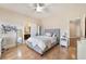 Bright bedroom with wood floors, ceiling fan, and access to an ensuite bathroom at 837 Roseberry Dr, Las Vegas, NV 89138