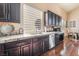 Well-lit kitchen with dark cabinets, stainless steel appliances, and granite countertops at 837 Roseberry Dr, Las Vegas, NV 89138