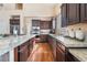 Contemporary kitchen featuring dark wood cabinets, stone countertops, and stainless steel appliances at 837 Roseberry Dr, Las Vegas, NV 89138
