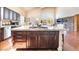 Spacious kitchen with dark wood cabinetry, granite counters, a large island, and stainless steel appliances at 837 Roseberry Dr, Las Vegas, NV 89138