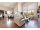 Bright living room with hardwood floors, stone fireplace, soaring windows, and comfortable seating at 837 Roseberry Dr, Las Vegas, NV 89138
