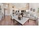 Open-concept living space with hardwood floors, stone fireplace, kitchen, and comfortable seating at 837 Roseberry Dr, Las Vegas, NV 89138