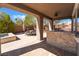 Covered outdoor kitchen with a built-in grill, bar seating, and a spacious patio area at 837 Roseberry Dr, Las Vegas, NV 89138
