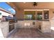 Well-equipped outdoor kitchen with stainless steel appliances and stone accents, great for hosting gatherings at 837 Roseberry Dr, Las Vegas, NV 89138