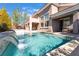Backyard features a sparkling pool with cascading waterfalls and covered patio area, perfect for relaxation at 837 Roseberry Dr, Las Vegas, NV 89138