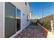 Cozy outdoor patio with pavers, a small seating area, and manicured landscaping at 8446 Vacarez Dr, Las Vegas, NV 89149