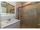 Modern bathroom featuring glass shower and vanity with a lighted mirror at 8446 Vacarez Dr, Las Vegas, NV 89149