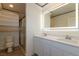 Bathroom featuring double sinks, LED mirror, and separate toilet and shower at 8446 Vacarez Dr, Las Vegas, NV 89149