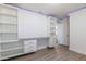 Comfortable bedroom with built-in desk, shelving, and wood-look laminate flooring at 8446 Vacarez Dr, Las Vegas, NV 89149