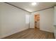 Well-lit room with a door leading to a walk-in closet, complemented by wood-look flooring at 8446 Vacarez Dr, Las Vegas, NV 89149