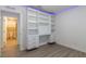 Bright bedroom with luxury vinyl plank flooring and custom built-in cabinets and shelving at 8446 Vacarez Dr, Las Vegas, NV 89149