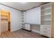 Bright bedroom with custom built-in shelving and desk, with a door that leads to walk-in closet at 8446 Vacarez Dr, Las Vegas, NV 89149