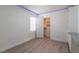 Bright bedroom with neutral walls, closet, and wood-look laminate flooring at 8446 Vacarez Dr, Las Vegas, NV 89149