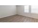 Bedroom with wood-look laminate flooring, and shuttered windows at 8446 Vacarez Dr, Las Vegas, NV 89149