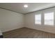 Serene room featuring wood-look flooring, plantation shutters, and natural light at 8446 Vacarez Dr, Las Vegas, NV 89149