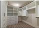 Organized walk-in closet with custom shelving, drawers, and hanging rods for ample storage at 8446 Vacarez Dr, Las Vegas, NV 89149