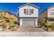 Charming two-story home with a well-manicured front yard, a two-car garage, and desert landscaping at 8446 Vacarez Dr, Las Vegas, NV 89149