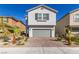 Charming two-story home with a brick driveway and desert landscaping at 8446 Vacarez Dr, Las Vegas, NV 89149