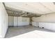 Organized garage with custom white cabinets, shelving units, and ample storage space at 8446 Vacarez Dr, Las Vegas, NV 89149