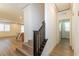 Inviting hallway featuring wood floors and a staircase with a dark wood handrail at 8446 Vacarez Dr, Las Vegas, NV 89149