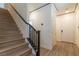 Hallway with a wood staircase, and white doors to other rooms of the house at 8446 Vacarez Dr, Las Vegas, NV 89149