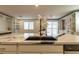 Modern kitchen island with a black sink and granite countertops at 8446 Vacarez Dr, Las Vegas, NV 89149