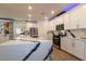 Kitchen featuring a marbled waterfall countertop island and stainless steel appliances, with white cabinets at 8446 Vacarez Dr, Las Vegas, NV 89149
