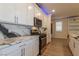 Modern kitchen featuring stainless steel appliances, white cabinets, and stylish marbled countertops at 8446 Vacarez Dr, Las Vegas, NV 89149
