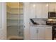Bright kitchen featuring a pantry and modern appliances and white cabinets at 8446 Vacarez Dr, Las Vegas, NV 89149